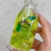 A hand holds a clear bottle filled with green fruit, labeled Chiboki, which is a drink cup toy.