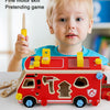 A toddler plays with a red wooden toy car and tools, including a screwdriver and wrench.