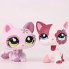 A pink and white Shorthair Cat Bobble Head figurine with large eyes and pink accents.