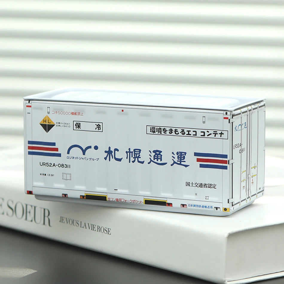 A white miniature industrial iron storage box labeled for preservation and transport on a white surface.
