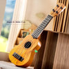 A wooden toy guitar is shown in a close-up, resting on a wooden surface.