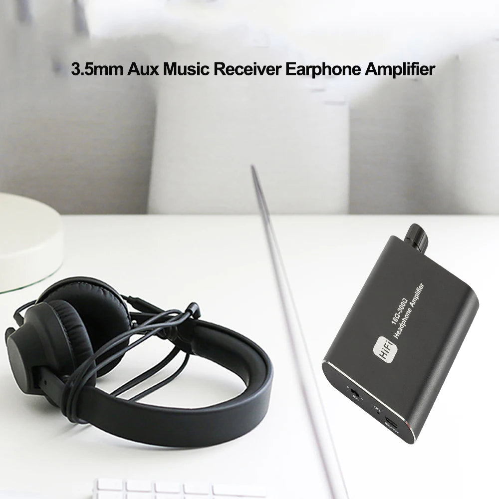A black portable HiFi headphone amplifier with a rechargeable battery is shown next to a pair of headphones.