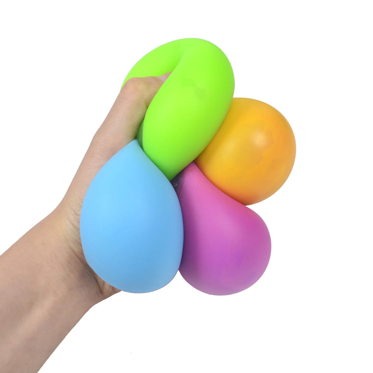 A hand is squeezing a stack of brightly colored stress relief balls, including lime green, orange, and blue.