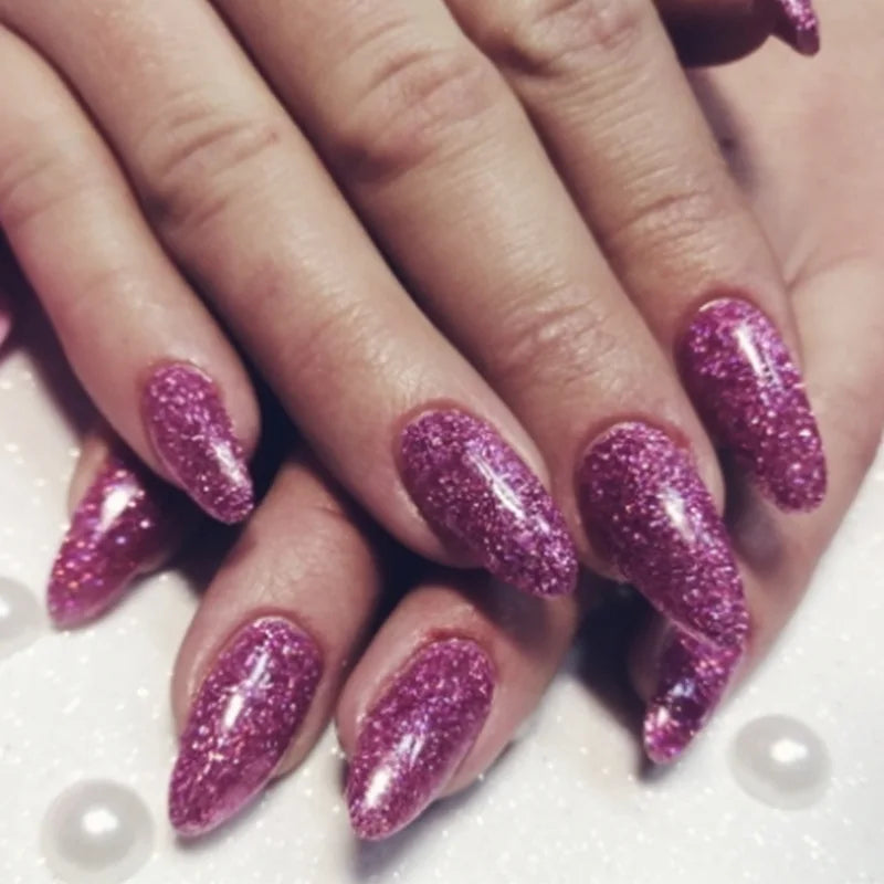 Close-up of fingers displaying a hand painted with holographic glitter nail polish.