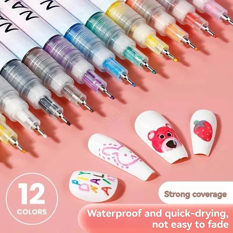 A collection of twelve colored precision nail art pens with fine tips displayed on a pink background.