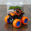 An orange and black monster truck toy sits in front of its packaging box.