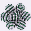 A cluster of ten green and silver mixed two-tone striped resin beads for jewelry making