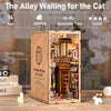 A wooden DIY book nook kit depicting The Alley Waiting for the Cat miniature scene with built-in lighting.