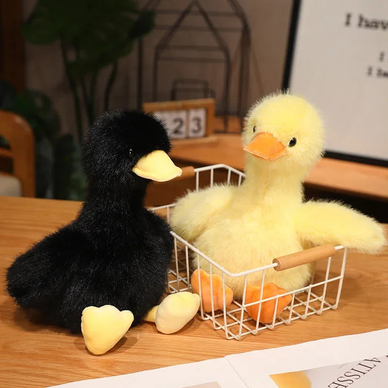 A black and yellow plush toy of a duck, resembling a realistic call duck stuffed animal, displayed in a wire basket.