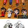 Keychain featuring a figure of Michael Jackson in various outfits and a pink car.