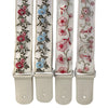 A set of three adjustable woven guitar straps featuring floral embroidery and leather accents.
