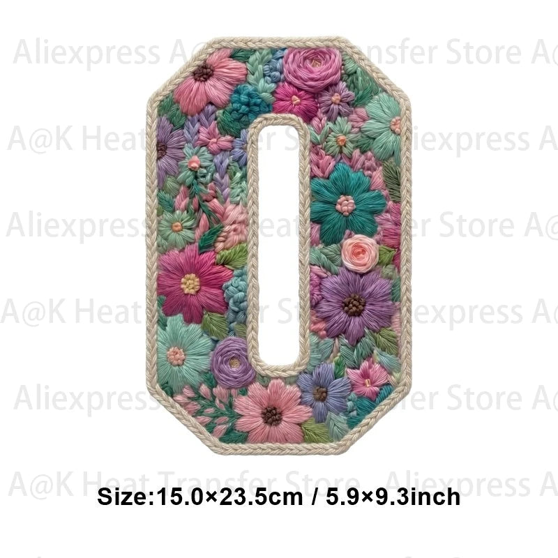 A large letter O made of floral fabric patches in shades of pink, purple, and green.