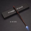A red LED light-up magic wand is displayed diagonally on a dark surface with the text Magic Wand visible.