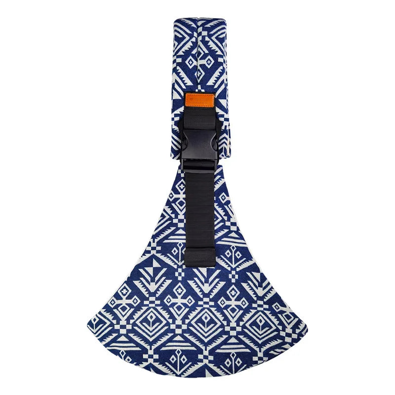 A patterned blue and white fabric sling carrier with a black strap and buckle.