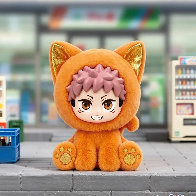 An orange cat-shaped collectible figure with pink hair and gold accents sitting on a gray surface.
