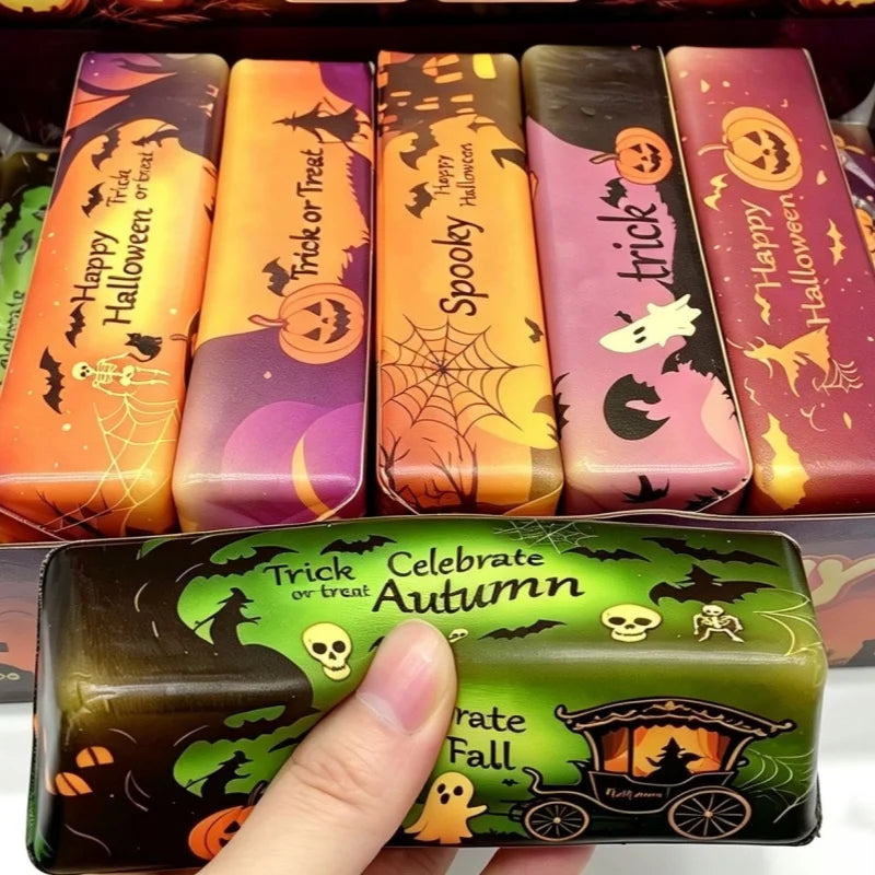 A collection of colorful squishy stress toys featuring Halloween themes like pumpkins and ghosts.