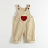 Tan corduroy overalls for a toddler featuring a red heart embroidery on the chest.