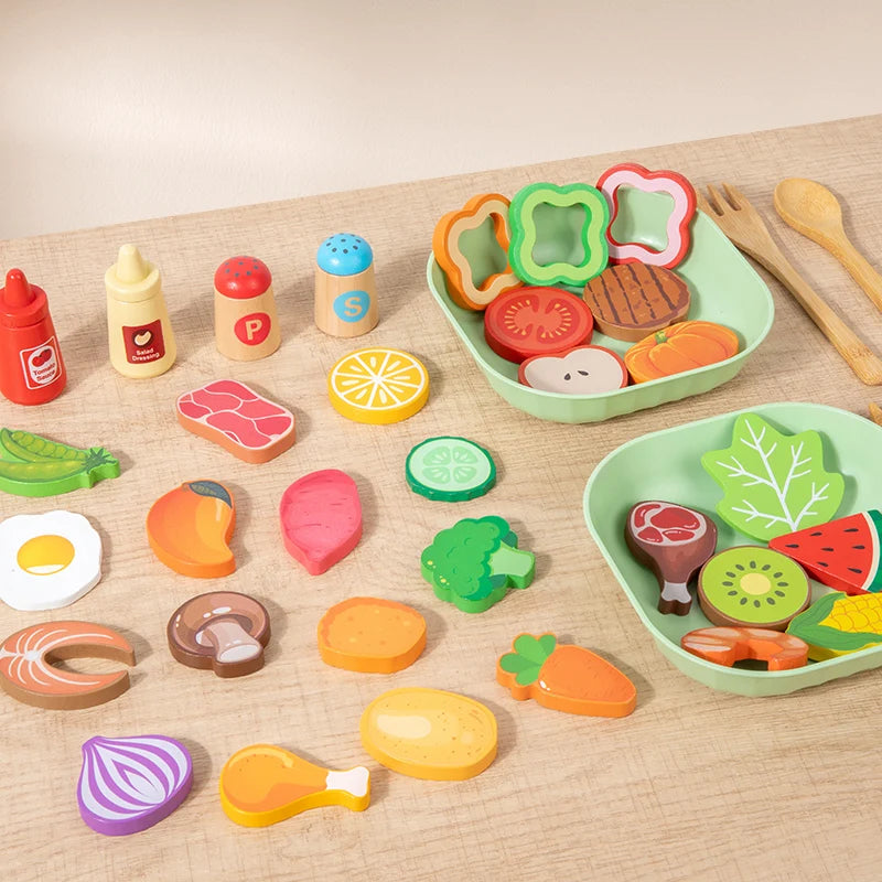 A collection of colorful wooden salad pretend play food items including vegetables and fruit on a light wooden surface.