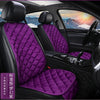 Interior view of a car seat with purple quilted fabric cushions and headrests.