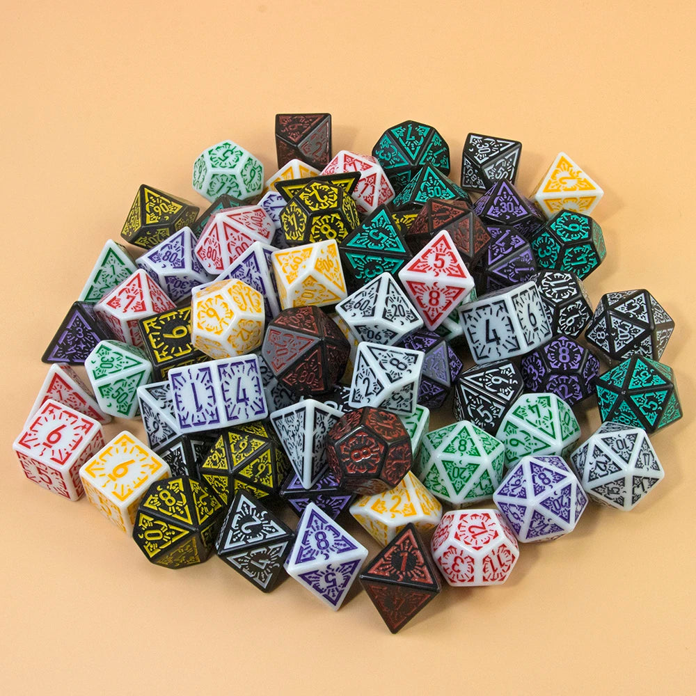 A collection of seven fantasy carved polyhedral dice in various colors and shapes arranged on a light background.