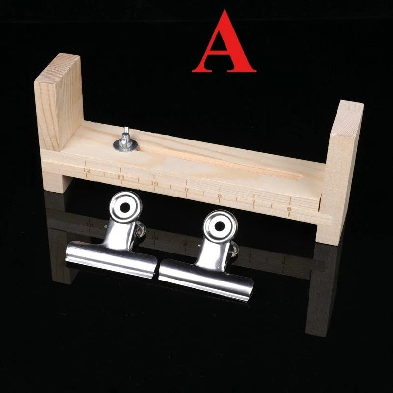 A wooden jig for bracelet weaving featuring a frame and two metal clips.
