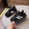 A pair of black and white casual sneakers resting on a light surface.