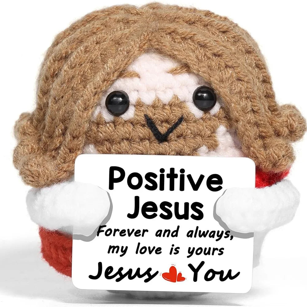 Handmade crochet Jesus doll with brown hair and white accents, featuring a sign that reads Positive Jesus Forever and always 