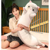 A white plush cat pillow is being held by a young woman in a casual indoor setting.