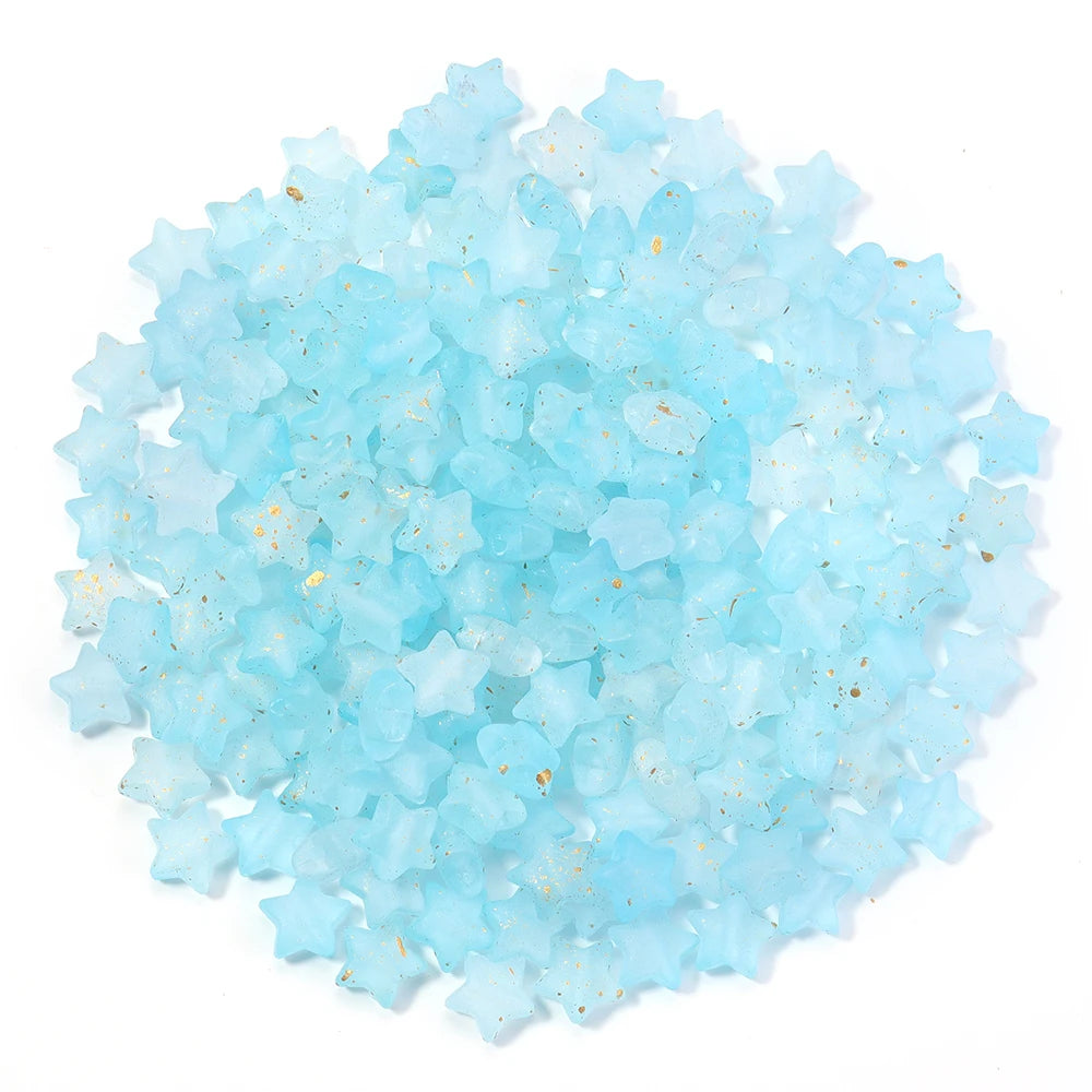 A pile of light blue transparent star acrylic beads for jewelry making