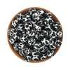 A pile of black and white spotted silicone beads for jewelry making