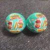 Two green mini vending machine toys filled with various snack dispensers and surprise balls