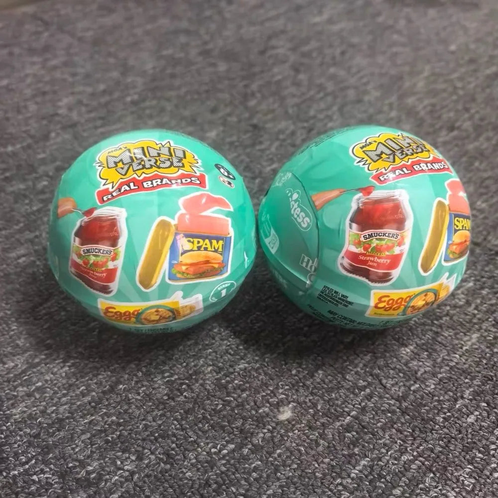 Two green mini vending machine toys filled with various snack dispensers and surprise balls