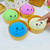 A collection of colorful, round squishy stress relief toys in pink, green, and blue are displayed on a white surface.