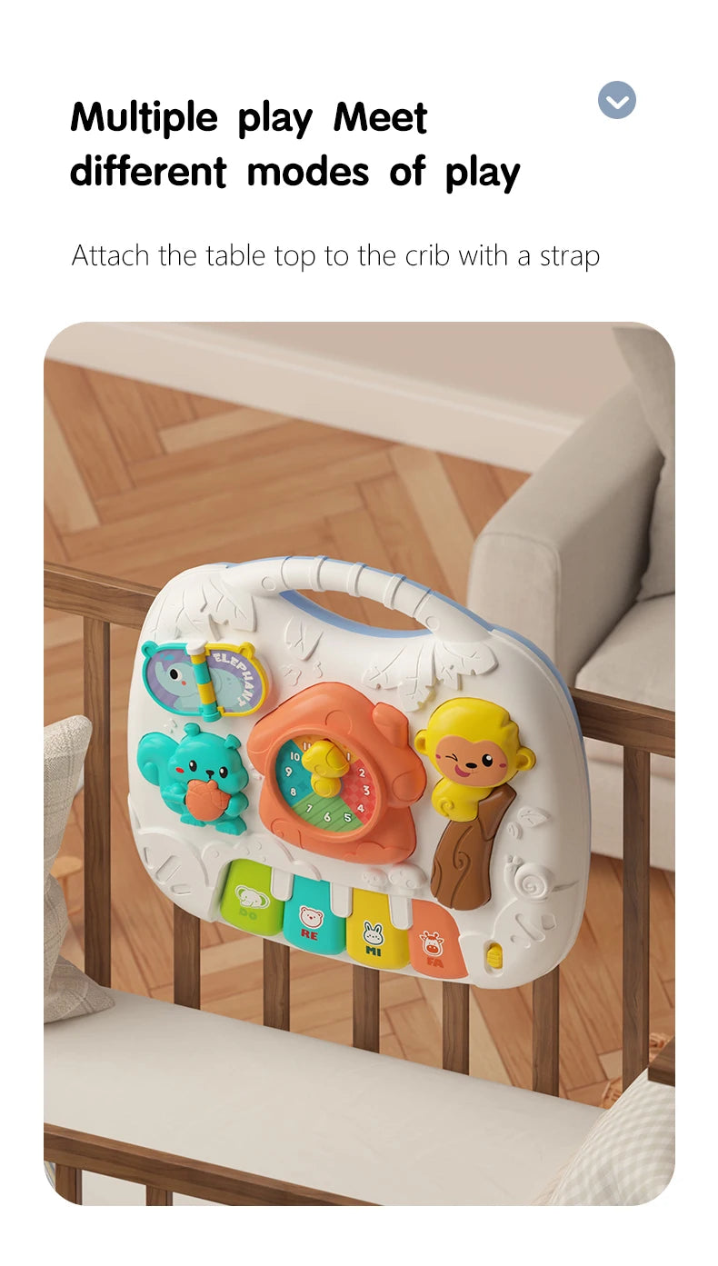 A white musical baby piano playmat with a light-up keyboard and hanging toys is shown attached to a crib.
