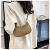 A beige PU square crossbody bag with a zipper closure is shown next to a light colored coat.