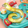 A yellow plastic kitchen sink toy with a curved spout and running water, featuring a red handle and a small yellow duck.