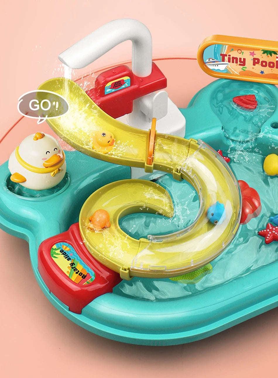 A yellow plastic kitchen sink toy with a curved spout and running water, featuring a red handle and a small yellow duck.