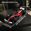 A red and black 1:8 scale open-wheel racing car model is displayed on a dark surface with size measurements.