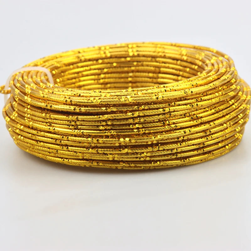 A coil of flexible gold-colored aluminum craft wire used for jewelry making and DIY projects.