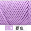 Close-up of a skein of light purple premium milk cotton yarn knitted into a textured fabric.