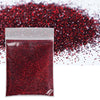 A sealed packet of fine red glitter powder scattered across a surface.