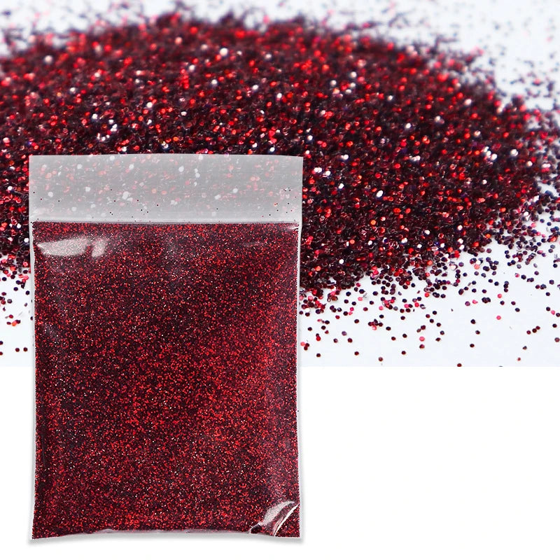 A sealed packet of fine red glitter powder scattered across a surface.