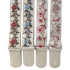 A set of three adjustable woven guitar straps featuring floral embroidery and leather accents.