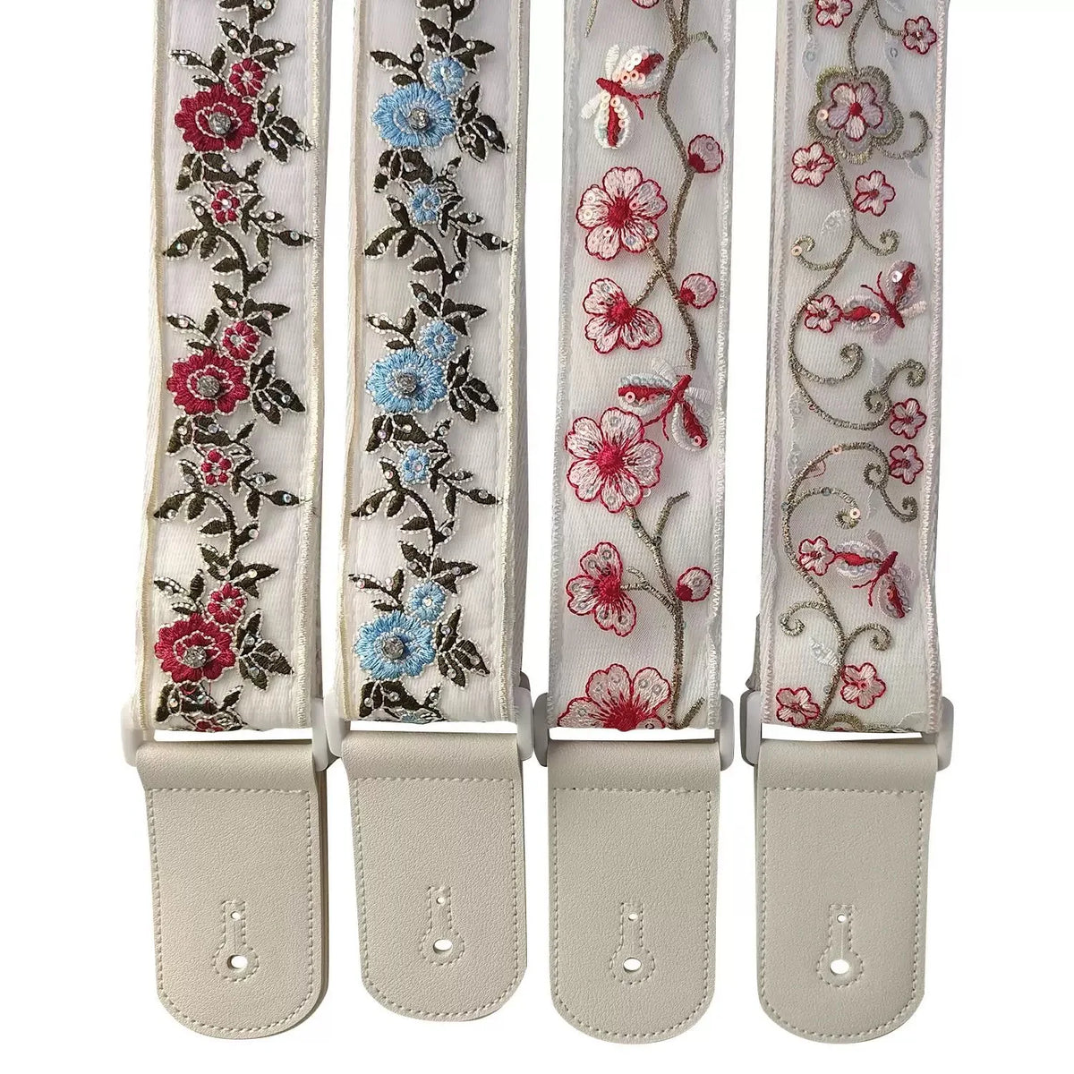 A set of three adjustable woven guitar straps featuring floral embroidery and leather accents.