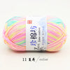 A ball of bright multi-colored yarn featuring pink, yellow, and light green threads.