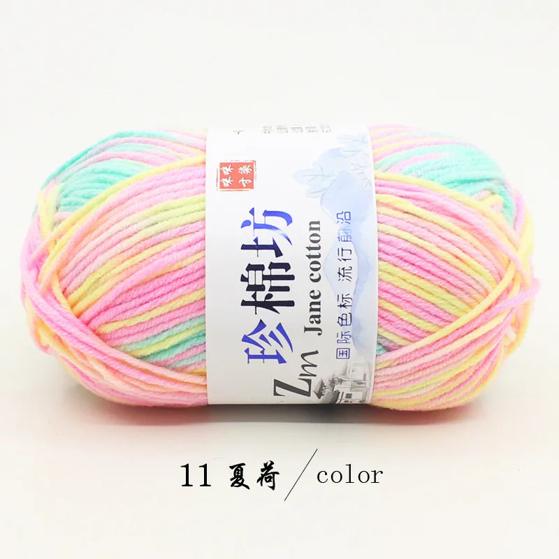 A ball of bright multi-colored yarn featuring pink, yellow, and light green threads.