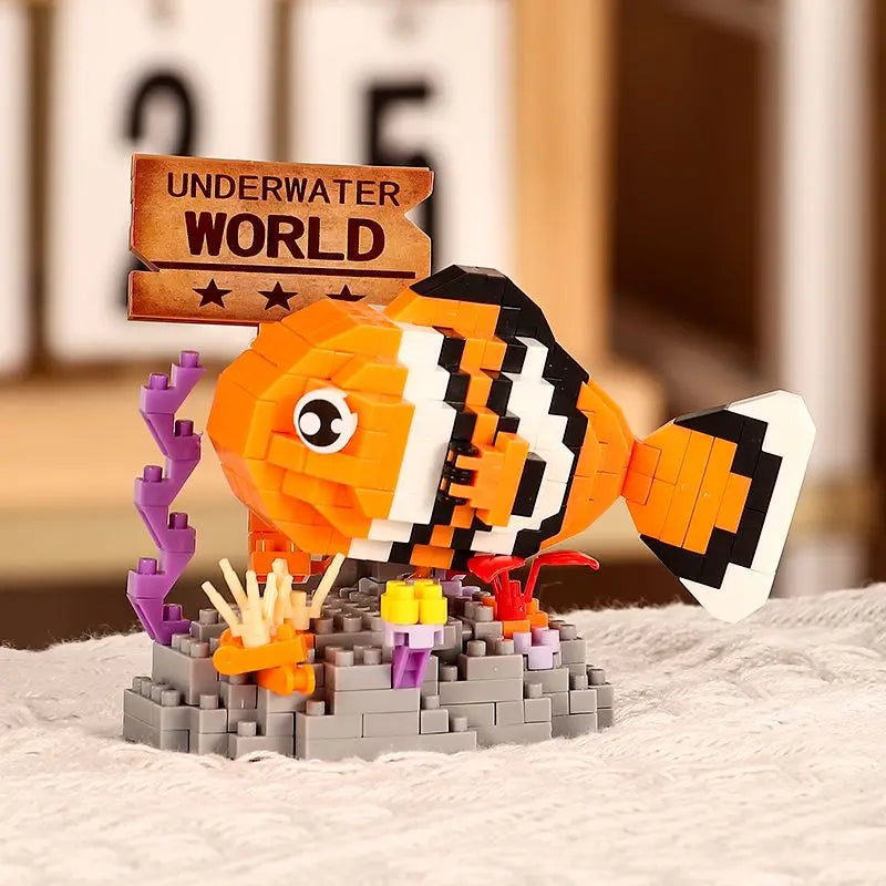 An orange and black shark building block model with purple tentacles and yellow accents on a gray base.