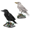 Two bird models, one black and one white, are displayed on building block bases.