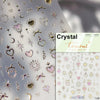 Sheet of Crystal and gold glitter nail art stickers featuring hearts stars moons and floral designs