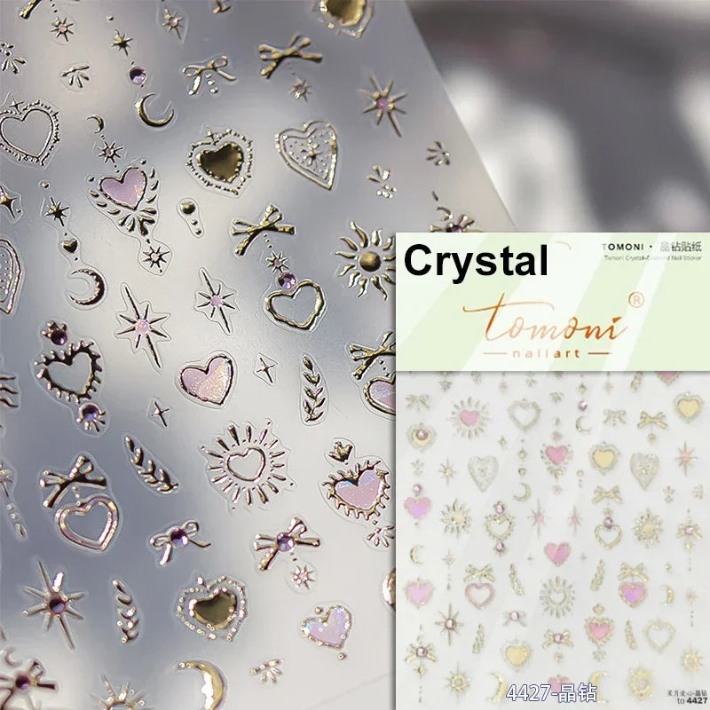 Sheet of Crystal and gold glitter nail art stickers featuring hearts stars moons and floral designs